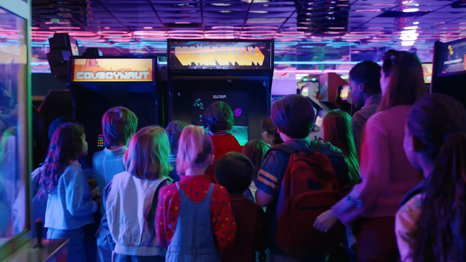 Game screen composited into the arcade scene