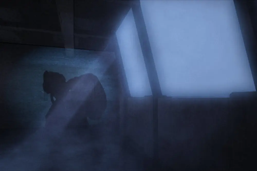 Silhouetted figure in volumetric light shafts