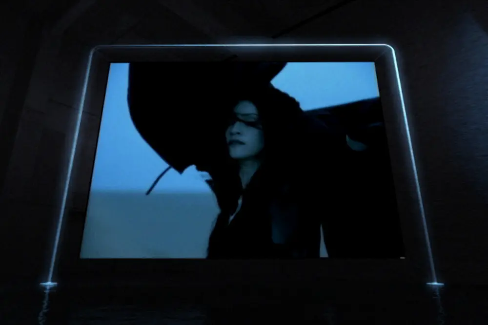 Single monumental screen glowing over the water floor