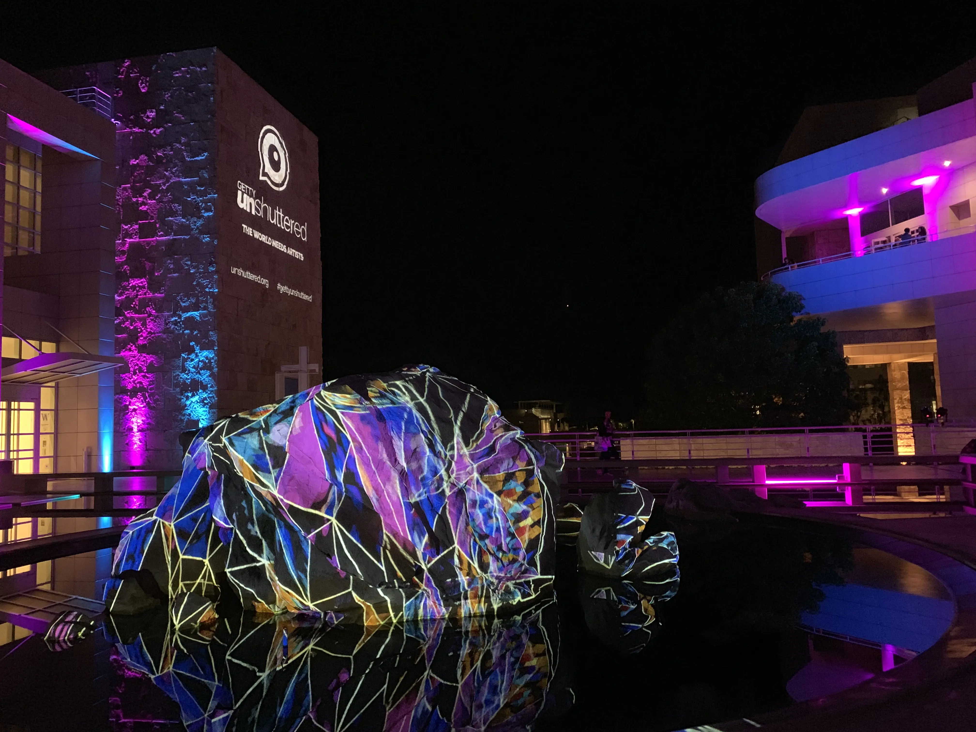 Wireframe-style projection on the fountain boulder