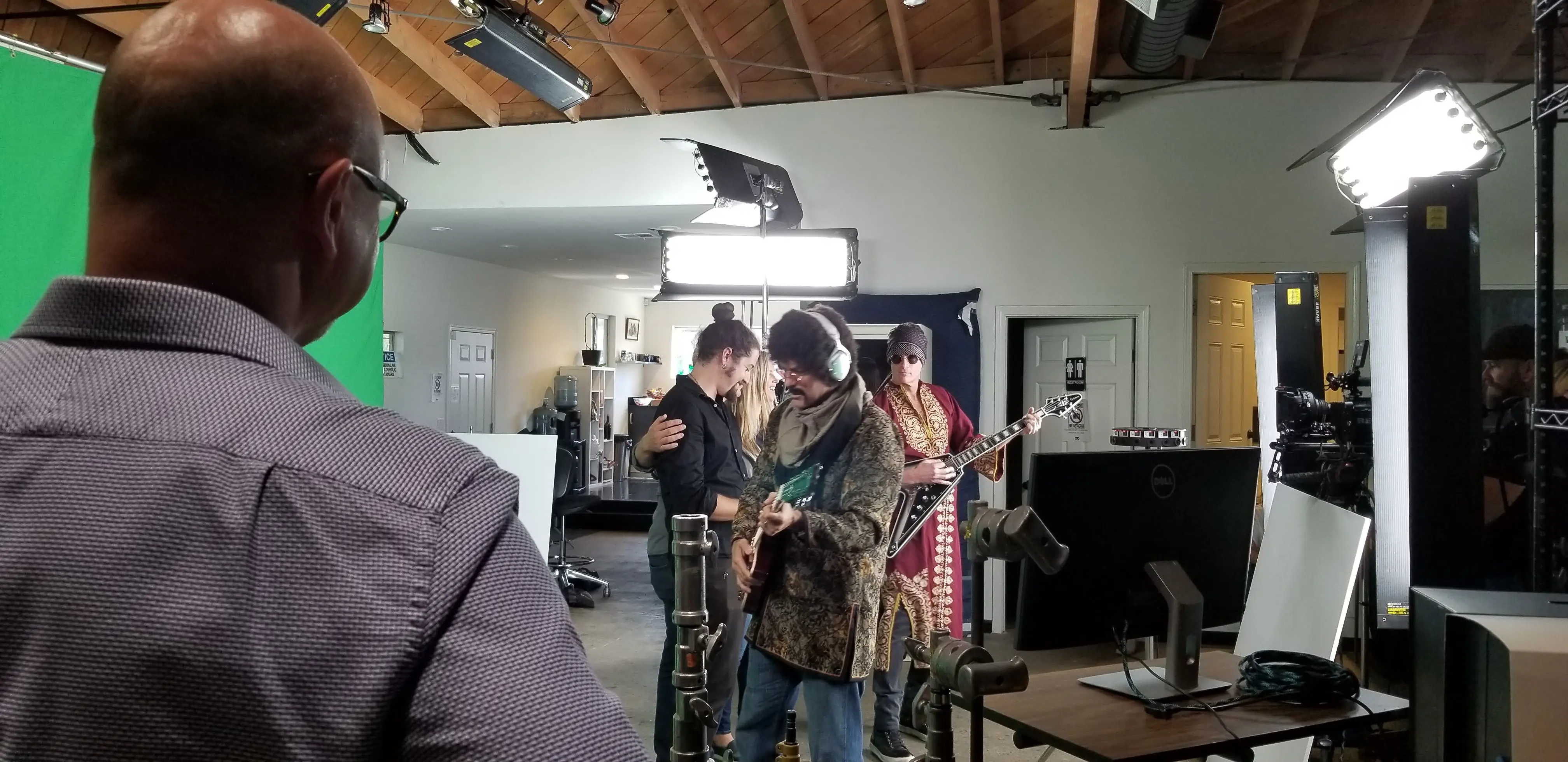 Green-screen studio setup with lighting and crew