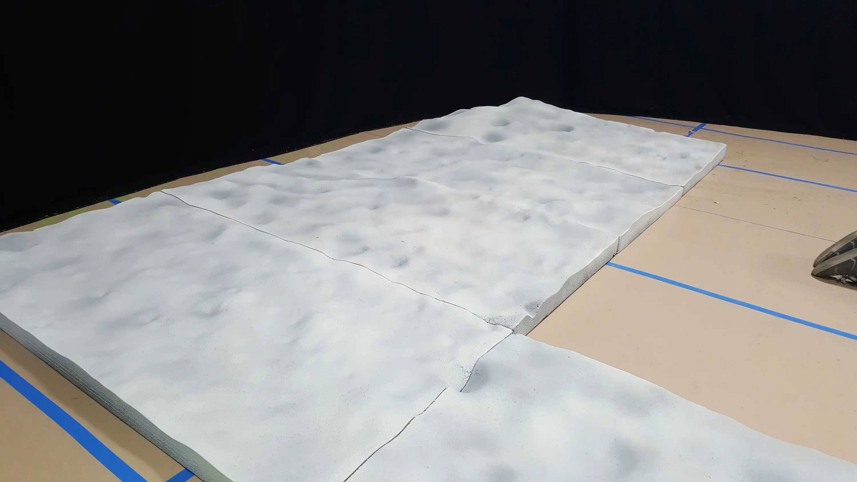 Sculpted foam lunar terrain on the stage